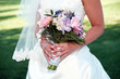 close up of bride holding pastel bouquet