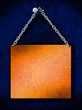 brass plate with steel chain hanging on a nail