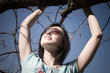 girl holding at the branch and looking up