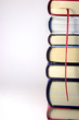 stack of books in a tower with a red bookmark