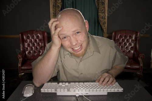Photo: worried man at computer worried man at computer