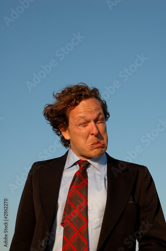 Photo: closeup of a crazy, psychiatric, salesman or busin closeup of a crazy, psychiatric, salesman or busin