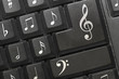 the keyboard of a computer with notes.