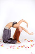 red-haired oriental dancer cambers backwards