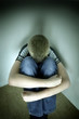 upset boy against a wall