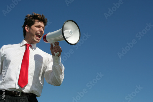 Photo: businessman shouting through megaphone businessman shouting through megaphone