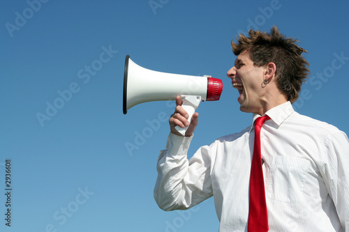 Photo: businessman shouting through megaphone businessman shouting through megaphone