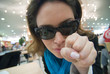 woman pionting at you in cafe