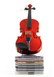 violin standing upright on stack of compact discs