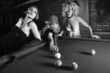 three retro females shooting pool.
