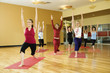 adult females in yoga class.