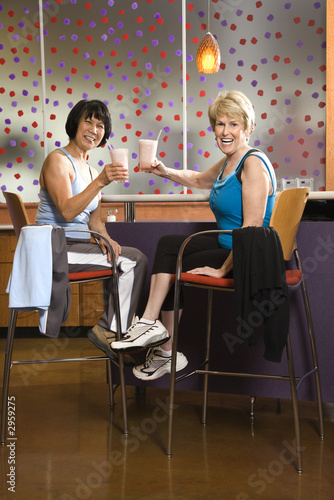 Photo: adult females sitting at table in health club. adult females sitting at table in health club.