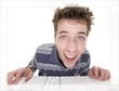 comical teenage boy enjoying computer