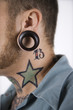 Photo: Adult male with tattoos and piercings. Adult male with tattoos and piercings.