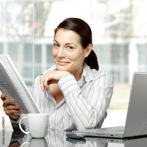 Photo: businesswoman reads document businesswoman reads document