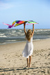 Photo: Girl holding kite on beach. Girl holding kite on beach.