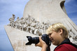 Caucasian boy with camera at the Monument to the Discoveries in