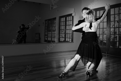Photo: two ballroom dancers practicing in their studio two ballroom dancers practicing in their studio