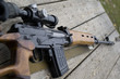 rifle gun laying on wooden desk