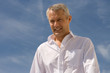 man, head and shoulders against blue sky