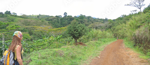 a trekker young woman with a dirty road, cameroon, africa, panor