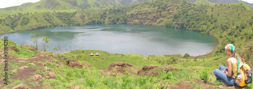 blue lake with a trekker woman sitting near, cameroon, africa, p
