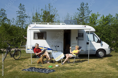 an elderly couple with camper