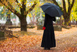 woman in mourning at cemetery in fall