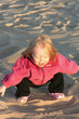 cute little girl playing on beach