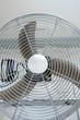 metal floor fan standing on tiled floor