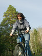 smiling girl riding on a bicycle