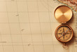 antique brass compass over old map