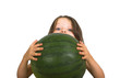 little girl peeking over watermelon