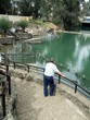 man looking at people baptizing in jordan river/is