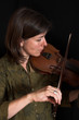 mid-age woman playing violon over black mid-age woman playing violon over black
