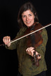 mid-age woman playing violon over black mid-age woman playing violon over black