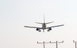 plane landing over guide towers
