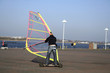 man windskating on street by seafront