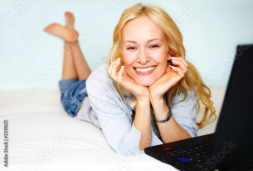 beautiful woman in bed with laptop