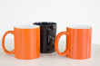 orange and black coffee mugs