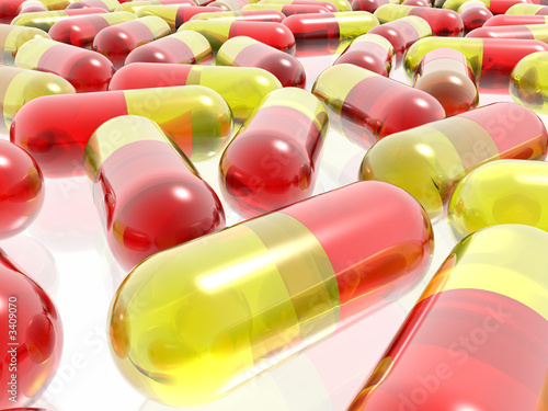 red and yellow pills on white background