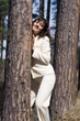 young women near pine trunks
