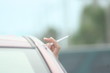 cigarette held  from car window