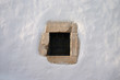 small window  in white lime wall