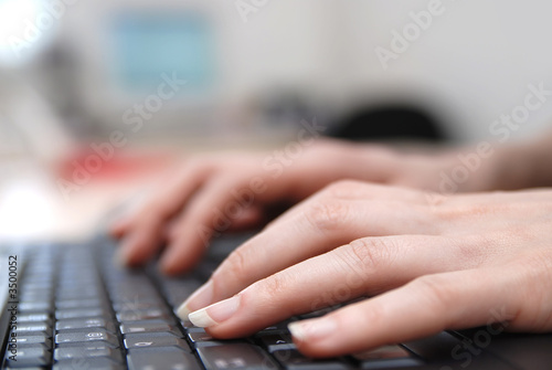 Photo: woman hands typing on laptop keyboard woman hands typing on laptop keyboard