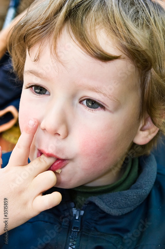 Photo: boy licks fingers boy licks fingers