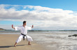 Photo: Man practicing Karate on the beach Man practicing Karate on the beach