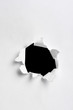 Black hole in white paper with ragged edges