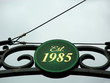Sign above local establishment providing origination date Sign above local establishment providing origination date