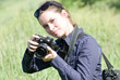 Lady with camera taking pictures in a park